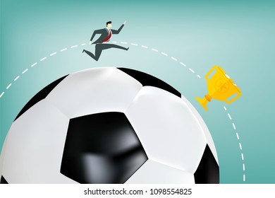 business man running follow a golden trophy cup around big soccer ball