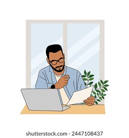 Business man sitting at desk, working on laptop. 