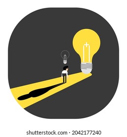 business man standing in front of a light bulb thinking