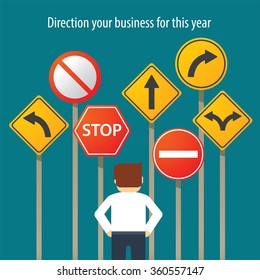 business man standing in front traffic signs