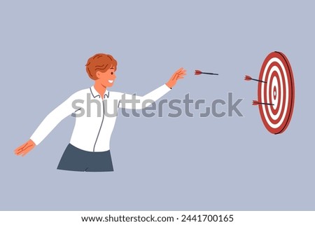 Business man is trying to hit target and achieve desired result by throwing darts at dartboard. Successful guy does not give up after first mistake and demonstrates perseverance in achieving target