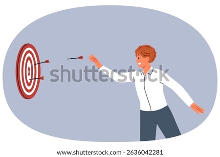 Business man is trying to hit target and achieve desired result by throwing darts at dartboard. Successful guy does not give up after first mistake and demonstrates perseverance in achieving target