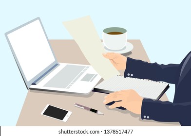 Business man is working on a computer and reading in paper in the office.