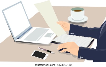 Business man is working on a computer and reading in paper in the office.