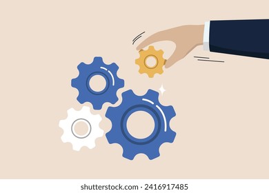 Business solutions to fix problems, leadership to connect business strategy concepts, businessman hands putting important equipment or cogs to make the machine run well.