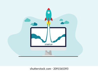 Business Start up concept, Rocket flying up and word startup on computer screen over blue background. 