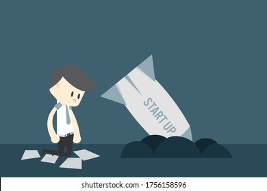Business startup failure concept, broken rocket on floor with owner sit near 