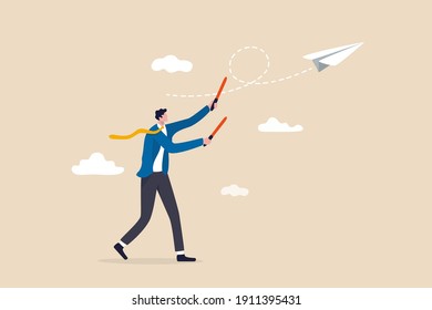 Business strategy or leadership to control working project to success and achieve target concept, smart confident businessman leader using air traffic control light to launch origami paper airplane.