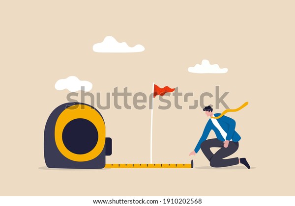 Business success measurement, how far from business\
goal and achievement or growth metric analysis concept, smart\
businessman using measuring tape to measure and analyze distance\
from target flag.