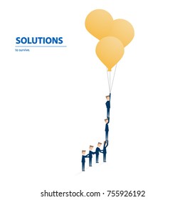 Business team flying with balloons to get out the old idea and find the new solutions. Business concept of teamwork, creativity, success, challenge and opportunity.