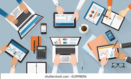 Business team working together at office desk, they are using laptops and checking financial reports, corporate management and accounting concept