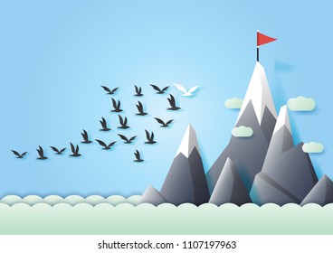 Business teamwork and leadership concept with group of birds flying in arrow shape to red flag on the mountain.Paper art vector illustration.