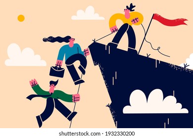 Business teamwork, leadership and support concept. Business leader standing on mountain peak helping team to climb to top of rock puling teammates to gain success together