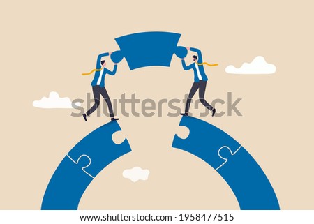 Business teamwork and partnership help to achieve team success, think together to solve business problem, business connection concept, businessmen working team building connect jigsaw puzzle bridge.