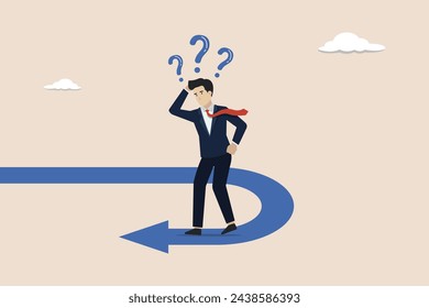 Business turning point, change direction,interest rate or financial trend change concept, businessman investor confused looking at reverse direction path.