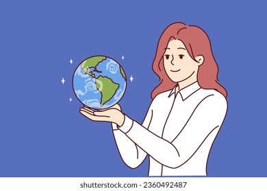 Business woman holding miniature planet earth dreaming of starting international company or global business. Girl with smile looks at globe with continents and dreams of going on trip around world.