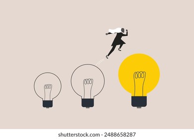 Business woman jumping on bigger lightbulb, successfully. concept of goal, achievement, advancement in career or business growth concept. Aspiration and motivation