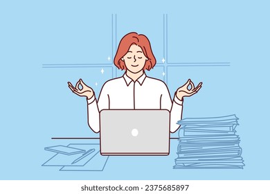 Business woman meditates sitting at office desk with papers and laptop and taking short break. Businesswoman meditates in lotus position and uses yoga practices to be more productive