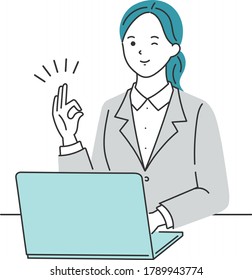 
Business woman posing OK in front of a laptop