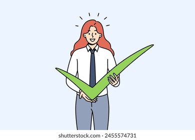 Business woman shows check mark as sign of confirmation of plans for cooperation or completion of project. Successful businesswoman with green check mark casts vote for favorite political candidate