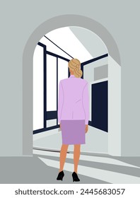 Business woman standing rear view in modern office