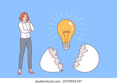 Business woman who has come up with new idea stands near light bulb that emerged from eggshell. Successful young girl corporate employee, developed idea for startup after brainstorming