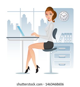Business woman working on a laptop computer at her office desk
