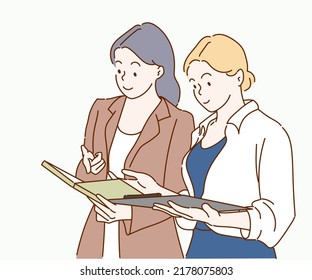 Business women looking at tablet and working together in office workspace.Team work concept. Hand drawn in thin line style, vector illustrations.