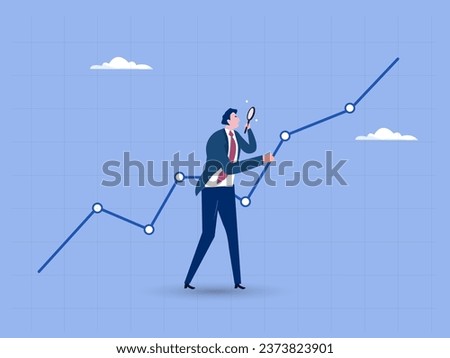 Businessman analyst using magnifying glass look in details on market data rising graph. Stock market data analysis, financial research professional or investment and economic forecast concept.
