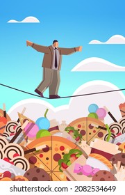 businessman balancing on rope above junk food assortment of fast food unhealthy nutrition junkfood addiction