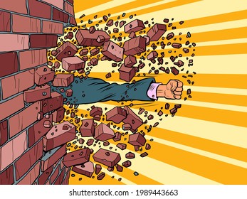 Businessman breaks through a brick wall. The will to overcome obstacles