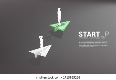 Businessman and businesswoman standing on money banknote origami paper airplane is move faster than the white. Business Concept of fast lane for moving and start up.