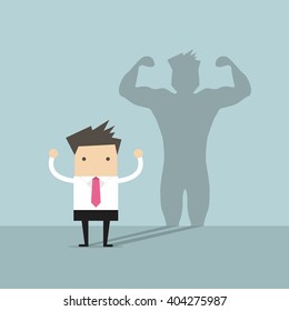 Businessman casting strong man shadow