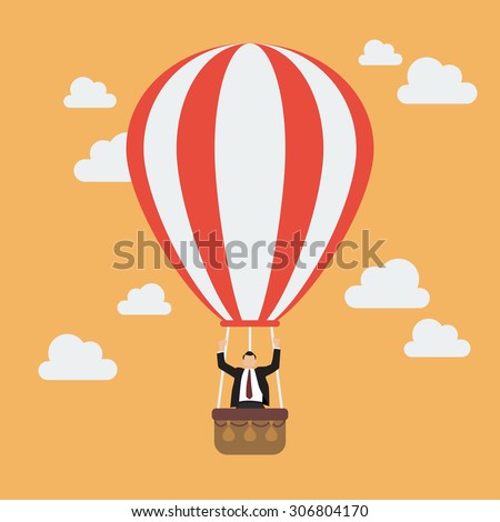 Businessman celebrating in hot air balloon