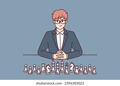 Businessman with chess pieces sits at table and looks at screen for concept of strategic planning in business. Man ceo of large corporation near chess symbolizing mind and strategic thinking