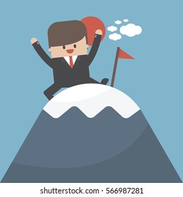 Businessman climbed to the top of the mountain and enjoys victory.
