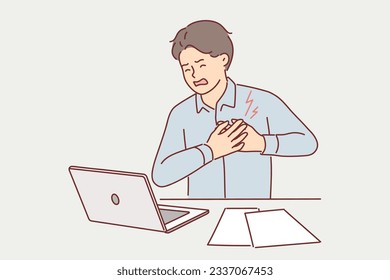 Businessman clutching heart feeling pain or infarct doing paperwork in office. Man sitting at desk with laptop experiencing heart attack associated with sedentary work and lack of rest