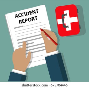 Businessman Completing Accident Report document beside First Aid Kit - Health and Safety concept
