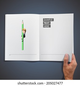 Businessman with crayons printed on book