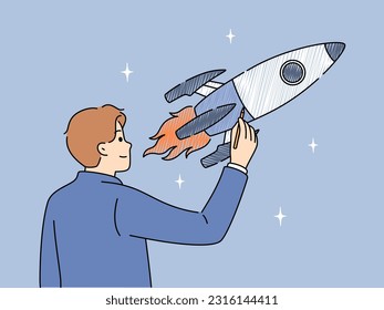 Businessman draws space rocket symbolizing successful launches and business ambitions or striving to achieve goals. Concept of starting and developing your own business or looking for investments