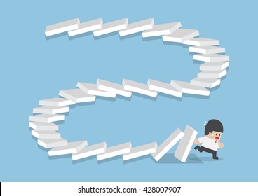 Businessman escaping from falling dominos, domino effect, bankruptcy, business crisis concept