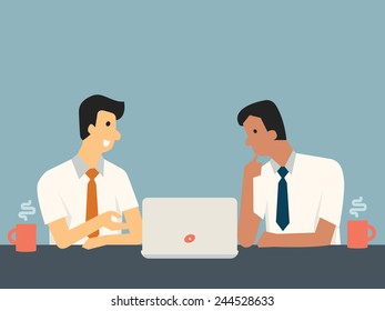Businessman explaining something in front of computer laptop for his colleague at workplace. 