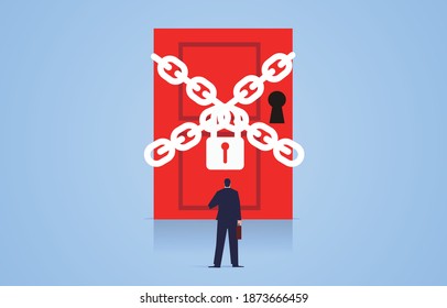 Businessman facing a door bound by chains