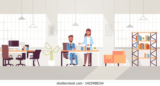 businessman with female assistant using laptop discussing new project during meeting at workplace teamwork concept creative workspace modern office interior flat full length horizontal