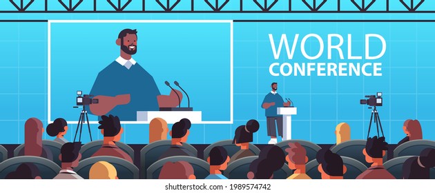 businessman giving speech at tribune with microphone on corporate international world conference