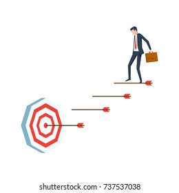 Businessman goes down the stair of arrows to the target