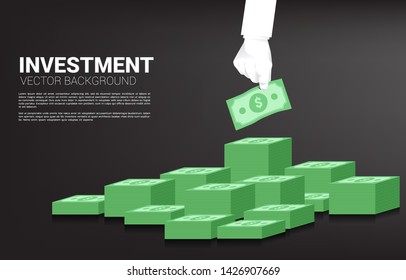 Businessman hand grabbing money from stack of banknote. Concept for business opportunity and economy