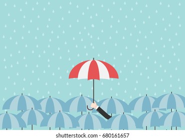 Businessman hand hold up red umbrella over blue umbrellas with raining background. Monsoon season. Rainy day. Vector illustration.