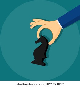 a businessman hand holding chess knight . strategic move concept. Business concept