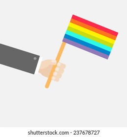 Businessman hand holding rainbow gay pride flag. Flat design style Vector illustration